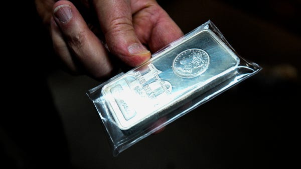 A 32oz bar of silver inside of Wilshire Coin, a pr