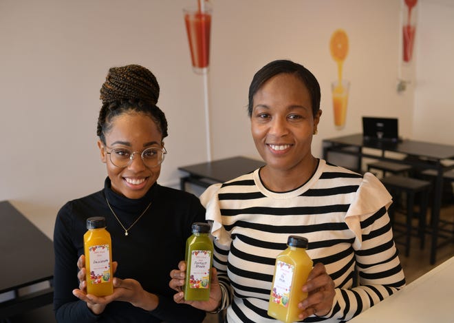 Unique Café's Kayanna James, left, and her mother, Nadine James, hold fresh homemade juice at their former location on Millbury Street in Worcester. The women closed the restaurant recently and are searching for a new location.