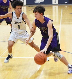 Millersport senior guard Mason Purvis dribbles past Grandview Heights' Trey Holliman during a Division IV district semifinal Tuesday night. The Lakers fell short, 57-35.