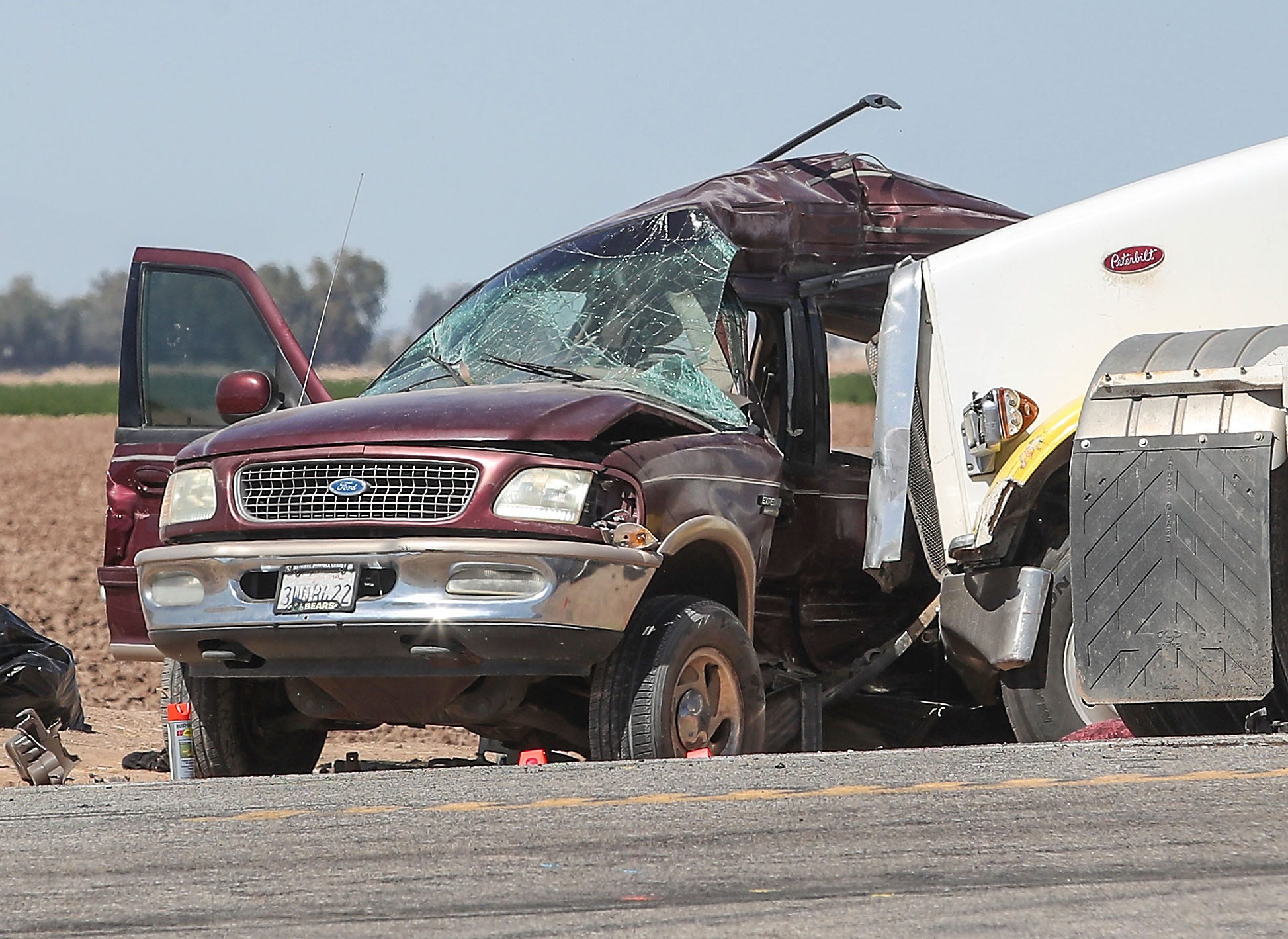 The Ford SUV that was destroyed when it crashed with a big rig sits on the side of Highway 115 near Holtville, Ca., as investigators try to determine what happened, March 2, 2021.