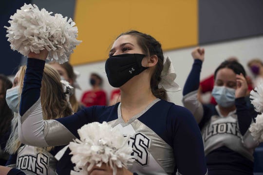 Feb. 27, 2021; Anthem, AZ, USA; North Valley Christian Academy's women's basketball player and cheerleader Bella Smith cheers for the men's basketball team from the sidelines at North Valley Christian Academy on Feb. 27, 2021. Credit: Meg Potter/The Arizona Republic