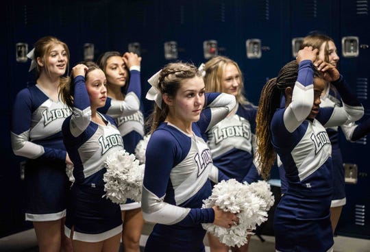 Feb. 27, 2021; Anthem, AZ, USA; North Valley Christian Academy's women's basketball and cheer team adjust their hair before having their photo taken at North Valley Christian Academy on Feb. 27, 2021. Credit: Meg Potter/The Arizona Republic
