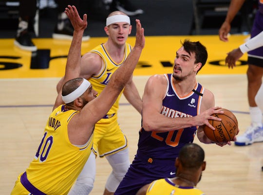 Mar 2, 2021; Los Angeles, California, USA; Phoenix Suns forward Dario Saric (20) moves to the basket against Los Angeles Lakers forward Jared Dudley (10) during the first half at Staples Center. Mandatory Credit: Gary A. Vasquez-USA TODAY Sports