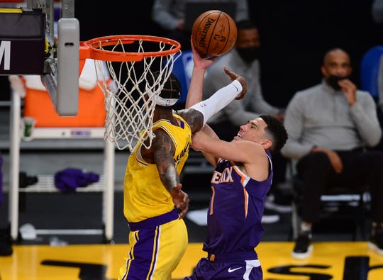 Mar 2, 2021; Los Angeles, California, USA; Phoenix Suns guard Devin Booker (1) moves to the basket but is fouled by Los Angeles Lakers guard Kentavious Caldwell-Pope (1) during the first half at Staples Center. Mandatory Credit: Gary A. Vasquez-USA TODAY Sports