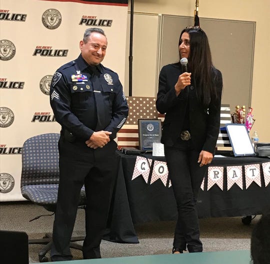 Gilbert police Officer David Bush stands with his wife, Eva DeCozio-Bush, at his retirement ceremony on Feb. 25, 2021, after serving in the Gilbert Police Department for 33 years.