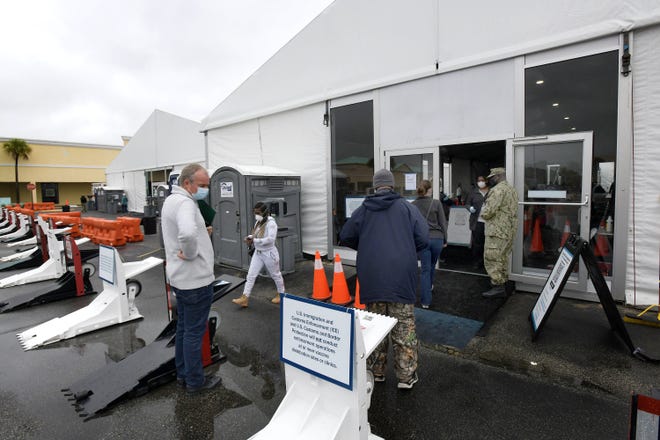 Active duty Navy personnel man the large event tents set up to house the new Federal COVID-19 vaccination site at the Gateway Town Center on Jacksonville, Florida's Northside Wednesday March 3, 2021. [Bob Self/Florida Times-Union]