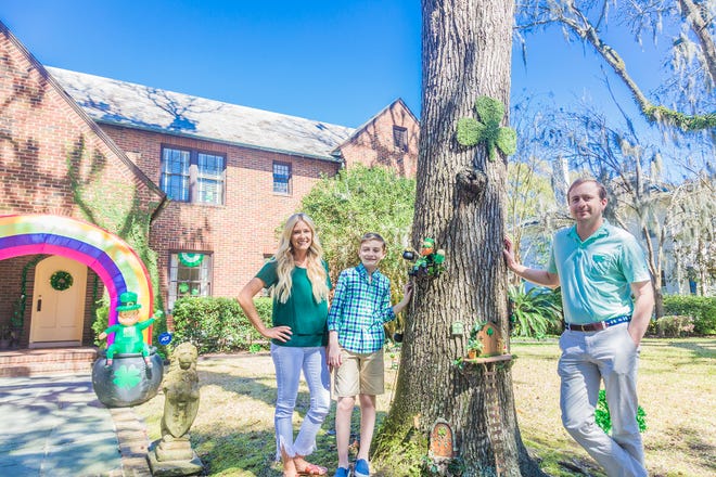Ashley Love, Aiden Adams and Tyler Love pose in front of their decorated Baldwin Park Home on East 45th Street.