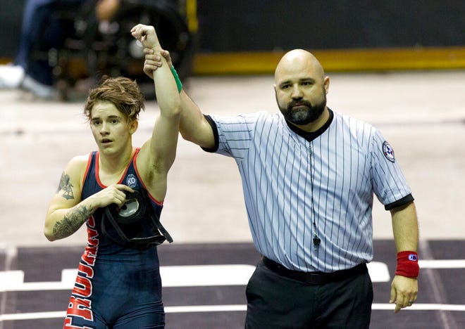 In this 2018 file photo, a referee raises the arm of Mack Beggs of Euless Trinity after he defeated Chelsea Sanchez of Morton Ranch to defend the Class 6A girls 110-pound title during the UIL State Wrestling Championships at the Berry Center in Cypress, Texas. (Jason Fochtman/Houston Chronicle via AP)