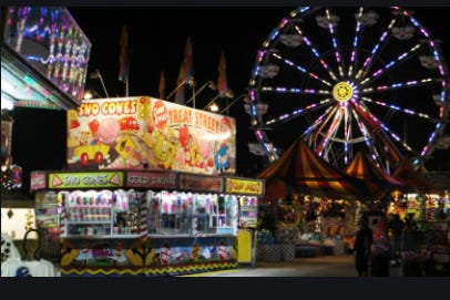 Scene from the midway at the Southwest Florida and Lee County Fair, which ends Sunday. The fair operator and a developer are competing for Lee County's nod for future use of the site.