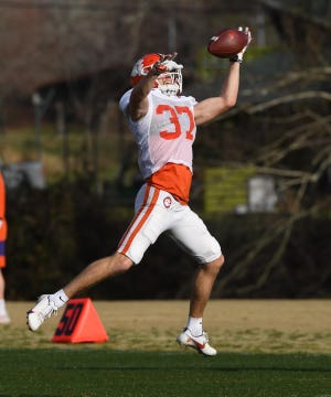 Clemson safety Jake Herbstreit goes up for a catch during practice.