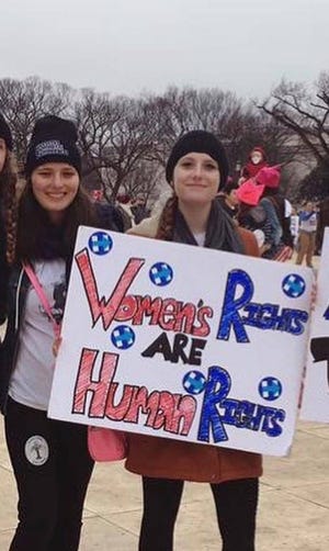 Katherine Barnes, left, and Charlotte Bennett - both students at Hamilton College at the time - at the Women's March on Washington in January 2017