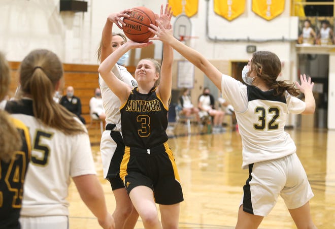 Montour's Courtney Slesinger (3) gets her two point shot blocked by Quaker Valley's Allie Ponzo (32) and Jordyn Ray (23) during the second half of the WPIAL 4A Playoffs Friday night at Quaker Valley High School.