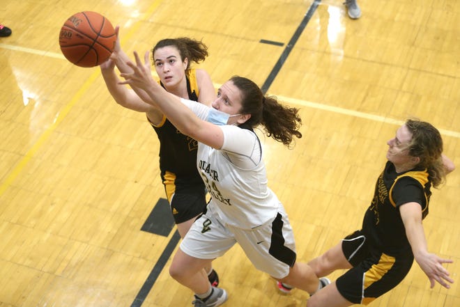 Quaker Valley's Claire Kuzma (34) fights for a rebound against Montour's Rachel Faith (21) during the second half of the WPIAL 4A Playoffs Friday night at Quaker Valley High School.