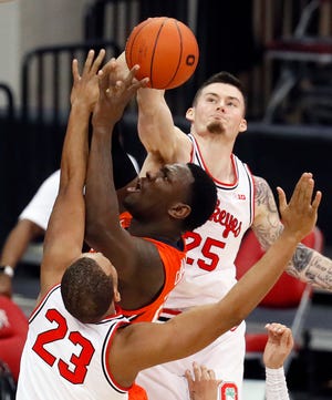 Ohio State Buckeyes forward Kyle Young (25) blocks Illinois Fighting Illini center Kofi Cockburn (21) during the first half of their game at Value City Arena in Columbus, Ohio on March 6, 2021.  