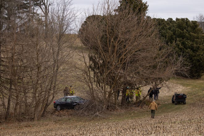 Crews work at the scene where a single vehicle crashed 300 feet off the road on the 2300 block of Black Rock Road, Saturday, March 6, 2021, in West Manheim Township. Bystanders pulled the confused man out of the vehicle after its engine briefly caught fire, with one bystander using a fire extinquisher to douse the flames, said Pleasant Hill Fire Chief Ted Clousher.