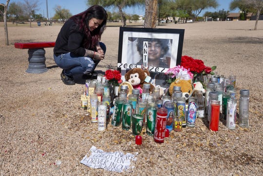Eva Cano cleans up a memorial site for her 17-year-old nephew, Anthony Cano, on March 5, 2021. He was shot twice in the back by a Chandler Police officer at Gazelle Meadows Park on Jan. 2, 2021, and taken to a hospital where he died three weeks later.