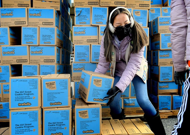 Girl Scout Meilynn Poletti, 15, of Troop #20455 in York, moves boxes of Girl Scout cookies during the annual Mega Drop cookie distribution at York Water Company's warehouse on Mt. Rose Avenue Saturday, March 6, 2021. About 10,000 cases, containing a dozen boxes of cookies each, were picked up to be distributed to over 200 troops. Bill Kalina photo