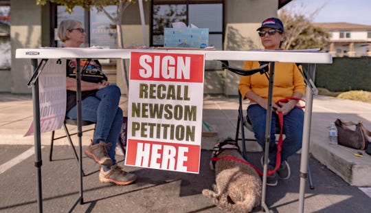 Janice Foster, left, and Lynda Baker collect signatures on Friday, March 5, 2021 in Visalia to recall California Governor Gavin Newsom. They said they and others have collected approximately 30,000 signatures. 