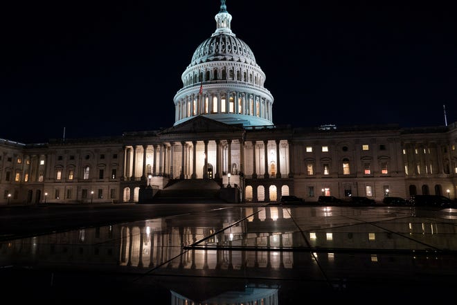 The Capitol is seen at dusk as work in the Senate is stalled on the Democrats' $1.9 trillion COVID-19 relief bill, in Washington, Friday, March 5, 2021.
