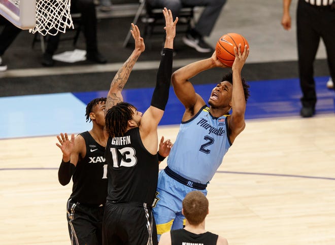 Mar 6, 2021; Milwaukee, Wisconsin, USA;  Marquette Golden Eagles forward Justin Lewis (2) shoots the ball against Xavier Musketeers forward Bryan Griffin (13) during the first half at Fiserv Forum. Mandatory Credit: Jeff Hanisch-USA TODAY Sports