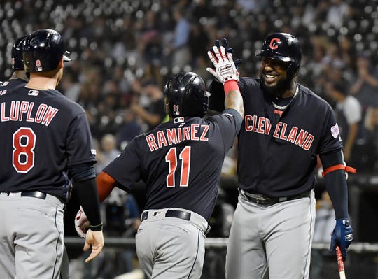 Cleveland Indians designated hitter Franmil Reyes (32) congratulates third baseman Jose Ramirez (11) for his grand slam in the first inning against the Chicago White Sox at Guaranteed Rate Field.