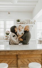 Liz Marie Galvan and her husband Jose, the duo behind the popular design website, the Liz Marie Blog, hold their son Copeland Beau in their west Michigan farmhouse. The couple have a new children's book about adoption.
