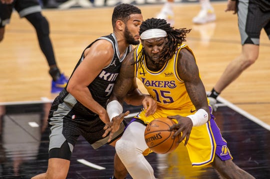 Los Angeles Lakers center Montrezl Harrell (15) drives to the basket as he's defended by Sacramento Kings guard Cory Joseph (9) during the second half of an NBA basketball game in Sacramento, Calif., Wednesday, March 3, 2021. (AP Photo/Hector Amezcua).