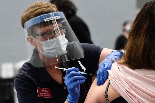 A nurse practitioner administers a dose of the Moderna COVID-19 vaccine at a clinic for Catholic school workers, including elementary school teachers, at Loyola Marymount University in Los Angeles on March 8.