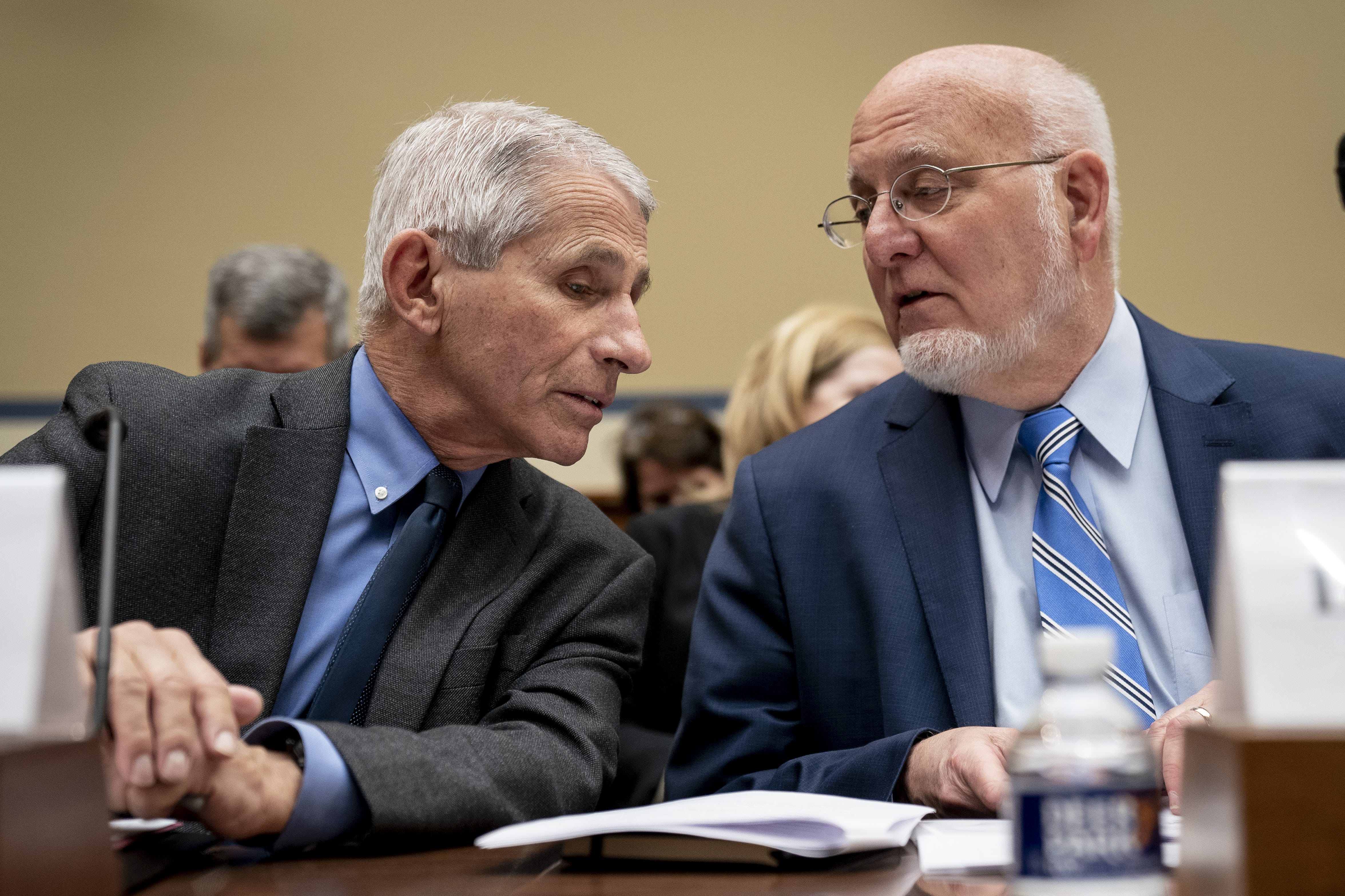 WASHINGTON, DC - MARCH 11: (L-R) Dr. Anthony Fauci, Director, National Institute of Allergy and Infectious Diseases at National Institutes of Health, and Dr. Robert Redfield, director of the Centers for Disease Control and Prevention (CDC), talk with each other at the start of a House Oversight And Reform Committee hearing concerning government preparedness and response to the coronavirus, in the Rayburn House Office Building on Capitol Hill March 11, 2020 in Washington, DC. Since December 2019, coronavirus (COVID-19) has infected more than 109,000 people and killed more than 3,800 people in 105 countries. (Photo by Drew Angerer/Getty Images) ORG XMIT: 775494460 ORIG FILE ID: 1206551329