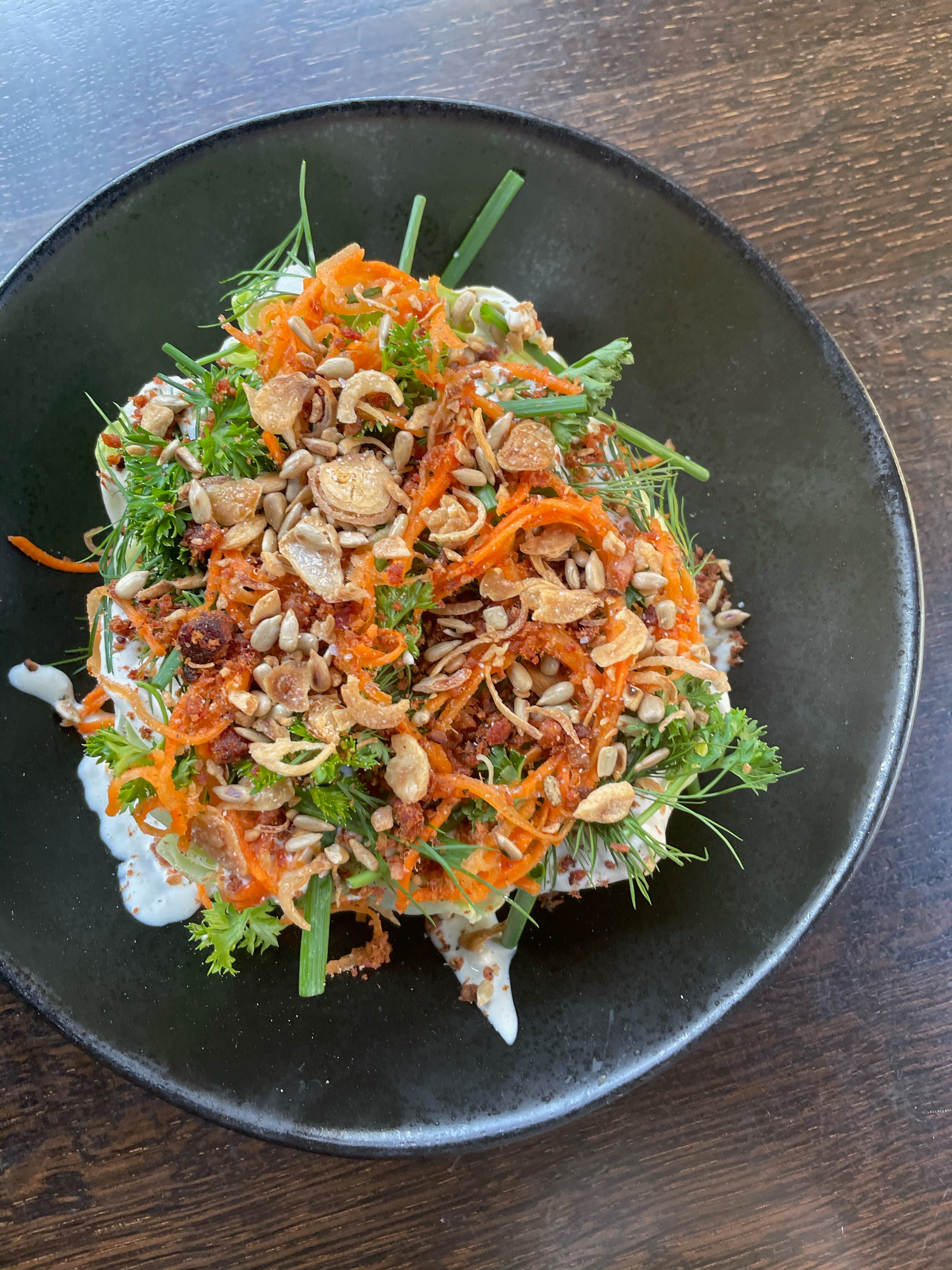 Smaller plates at Fool's Errand  include a wedge salad with blue cheese dressing, bacon, pickled carrot, herbs and "everything" crumble of sesame and sunflower seeds, garlic and shallots.