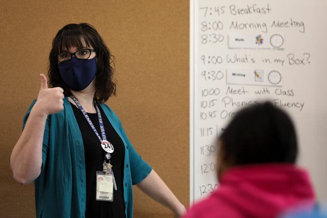 Jennifer Halverson instructs students during one of the first days back for 2nd and 3rd graders after closures due to the coronavirus, at Hoover Elementary School on Tuesday, March 9, 2021.