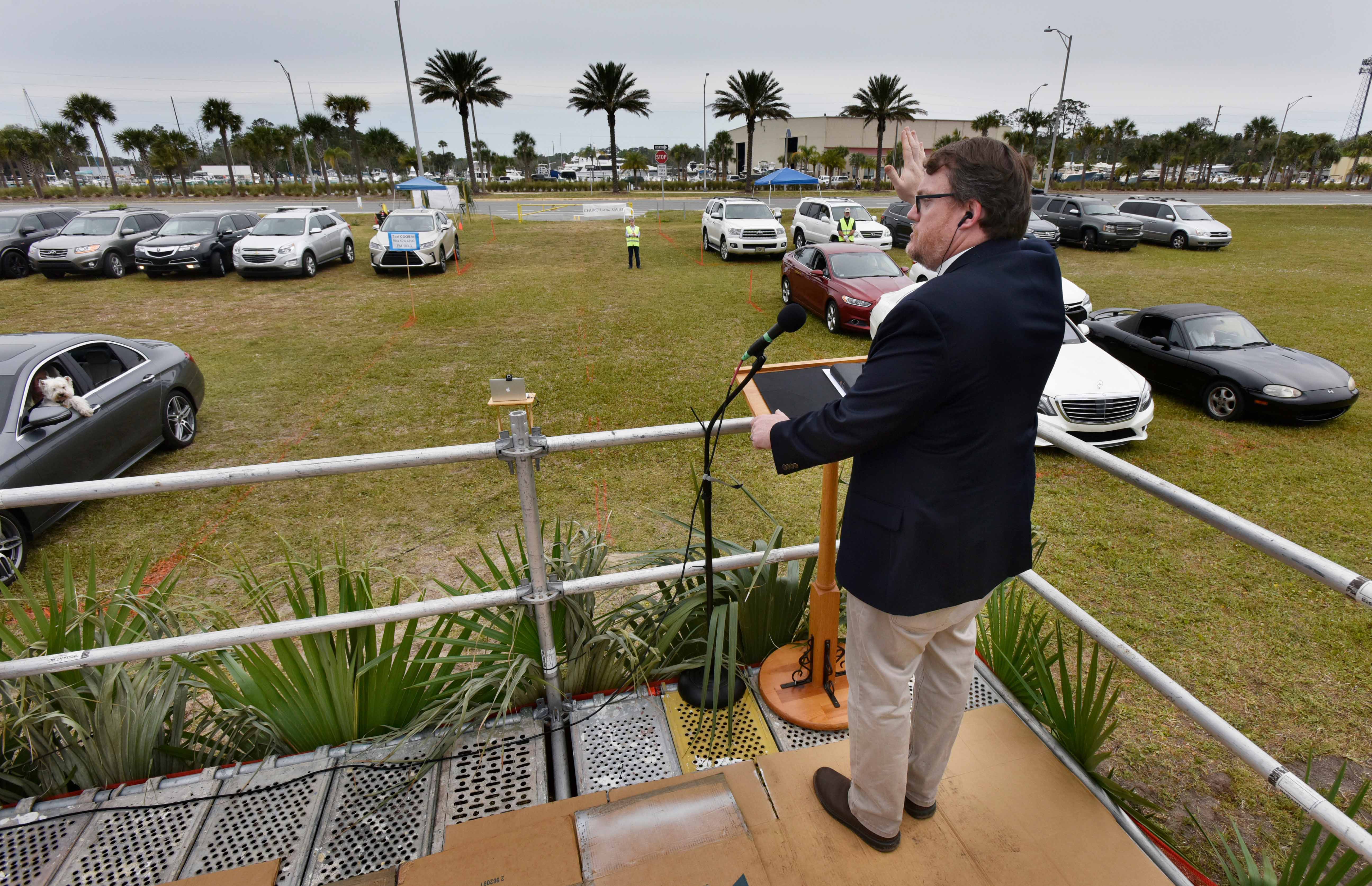 Senior Pastor David Ball of the Church of Our Savior on Beach Boulevard delivers his sermon on Palm Sunday at a drive-in church service  Sunday, April 5, 2020 in the middle of the coronavirus pandemic in Jacksonville Beach, Florida.