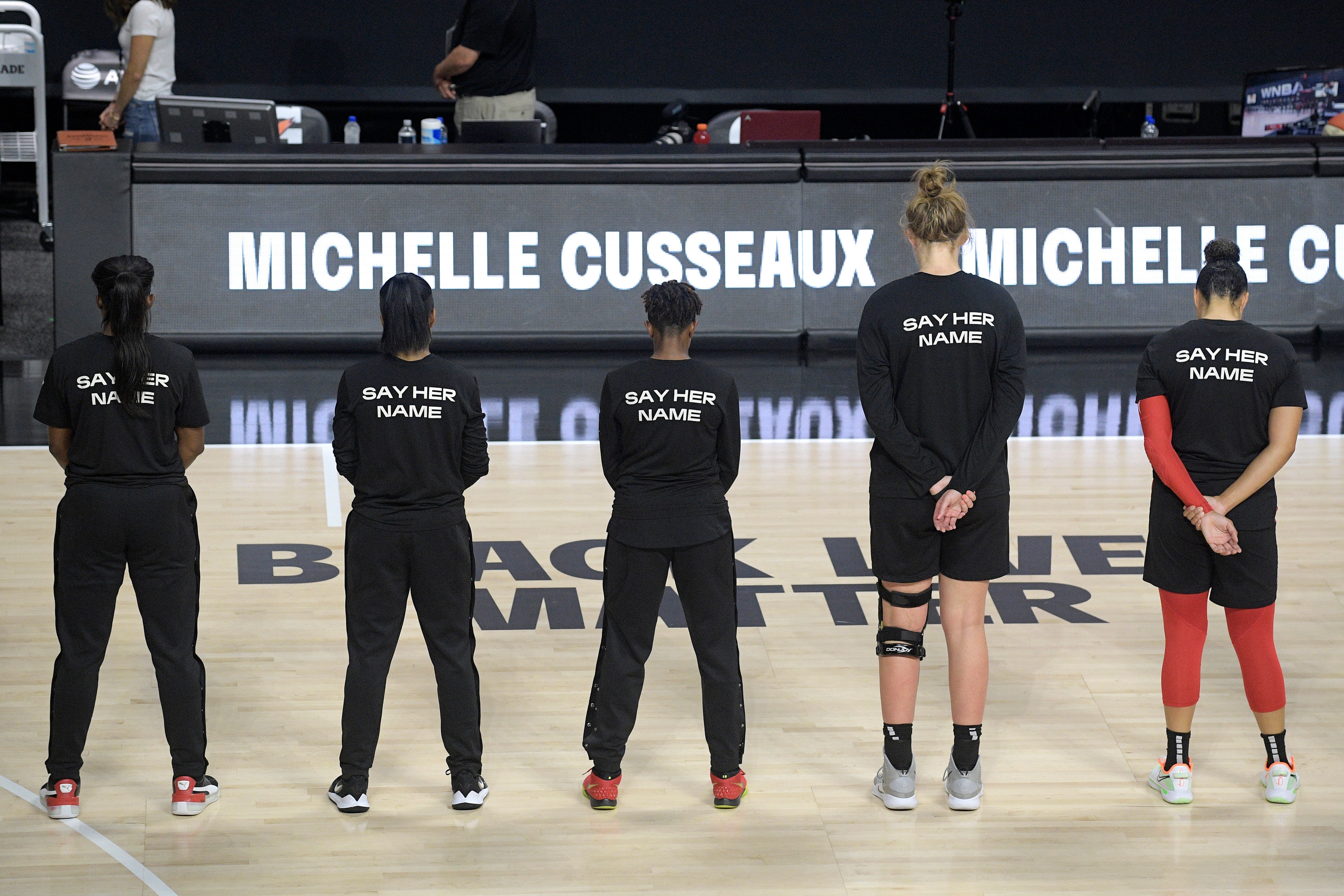 Members of the Las Vegas Aces honor Michelle Cusseaux with a moment of silence before a WNBA basketball game against the Washington Mystics, Aug. 15, 2020, in Bradenton, Fla.