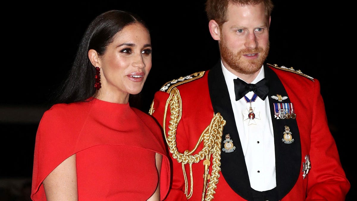 (FILES) In this file photo taken on March 07, 2020 Britain's Prince Harry, Duke of Sussex and Meghan, Duchess of Sussex arrive to attend The Mountbatten Festival of Music at the Royal Albert Hall in London. - Britain's Prince Harry will relinquish his honorary military appointments and patronages after confirming to Queen Elizabeth II that he and wife Meghan Markle will not return as working royals, Buckingham Palace announced on February 19, 2021. (Photo by   SIMON DAWSON / POOL / AFP) (Photo by SIMON DAWSON/POOL/AFP via Getty Images) ORG XMIT: 0 ORIG FILE ID: AFP_93D33H.jpg