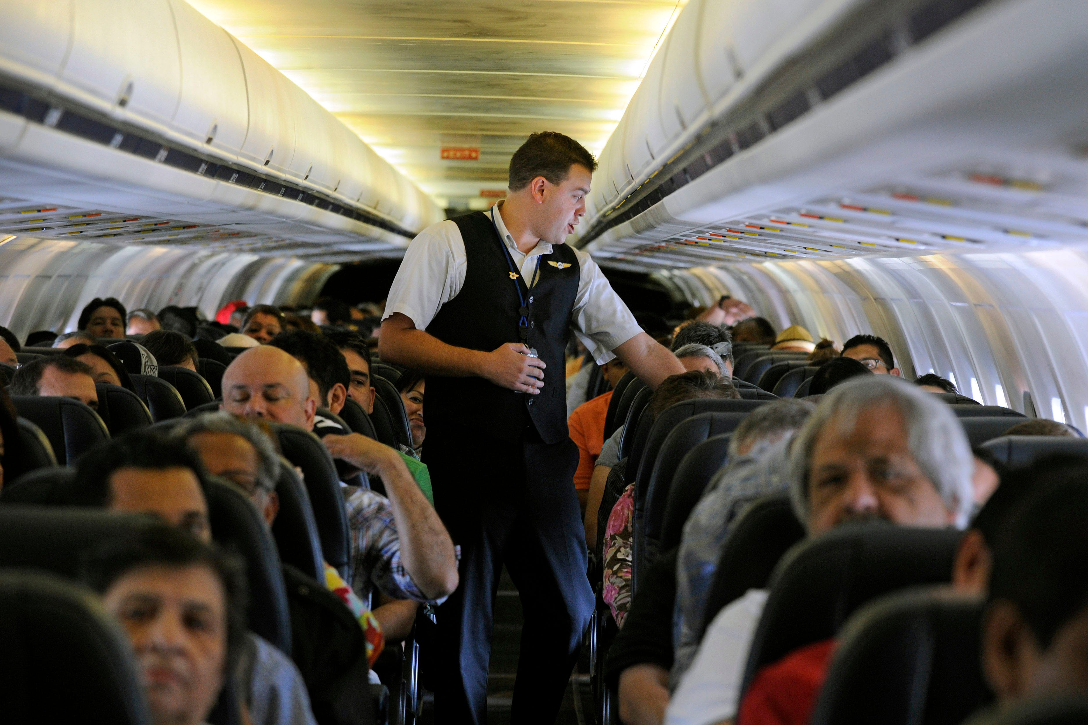 Allegiant Air flight attendant Chris Killian prepares his passengers for the Laredo, Texas, bound flight before it pushes back from the terminal at McCarran International Airport in Las Vegas, as seen in this May 9, 2013, file photo.