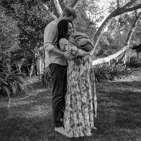 Prince Harry and Duchess Meghan of Sussex pose wit