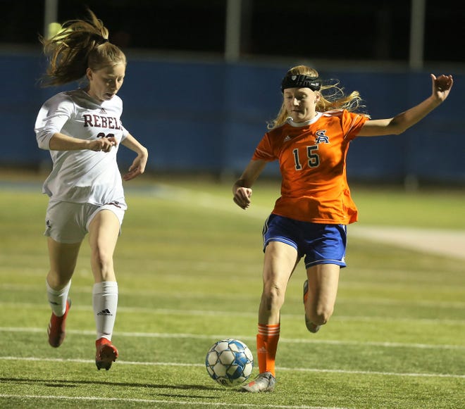 San Angelo Central High School's Ellie Barker, 15, beats a Midland Lee player to a loose ball during a District 2-6A soccer match at Old Bobcat Stadium on Tuesday, March 9, 2021.