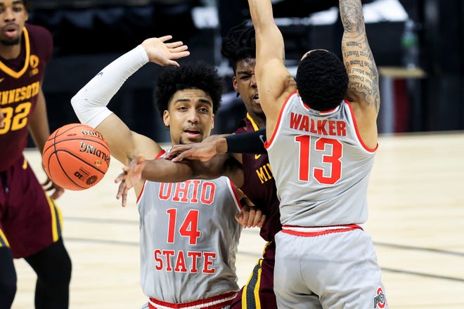 Mar 11, 2021; Indianapolis, Indiana, USA; Ohio State Buckeyes forward Justice Sueing (14) reacts as Minnesota Golden Gophers guard Marcus Carr (5) passes the ball against Ohio State Buckeyes guard CJ Walker (13) in the first half at Lucas Oil Stadium. Mandatory Credit: Aaron Doster-USA TODAY Sports