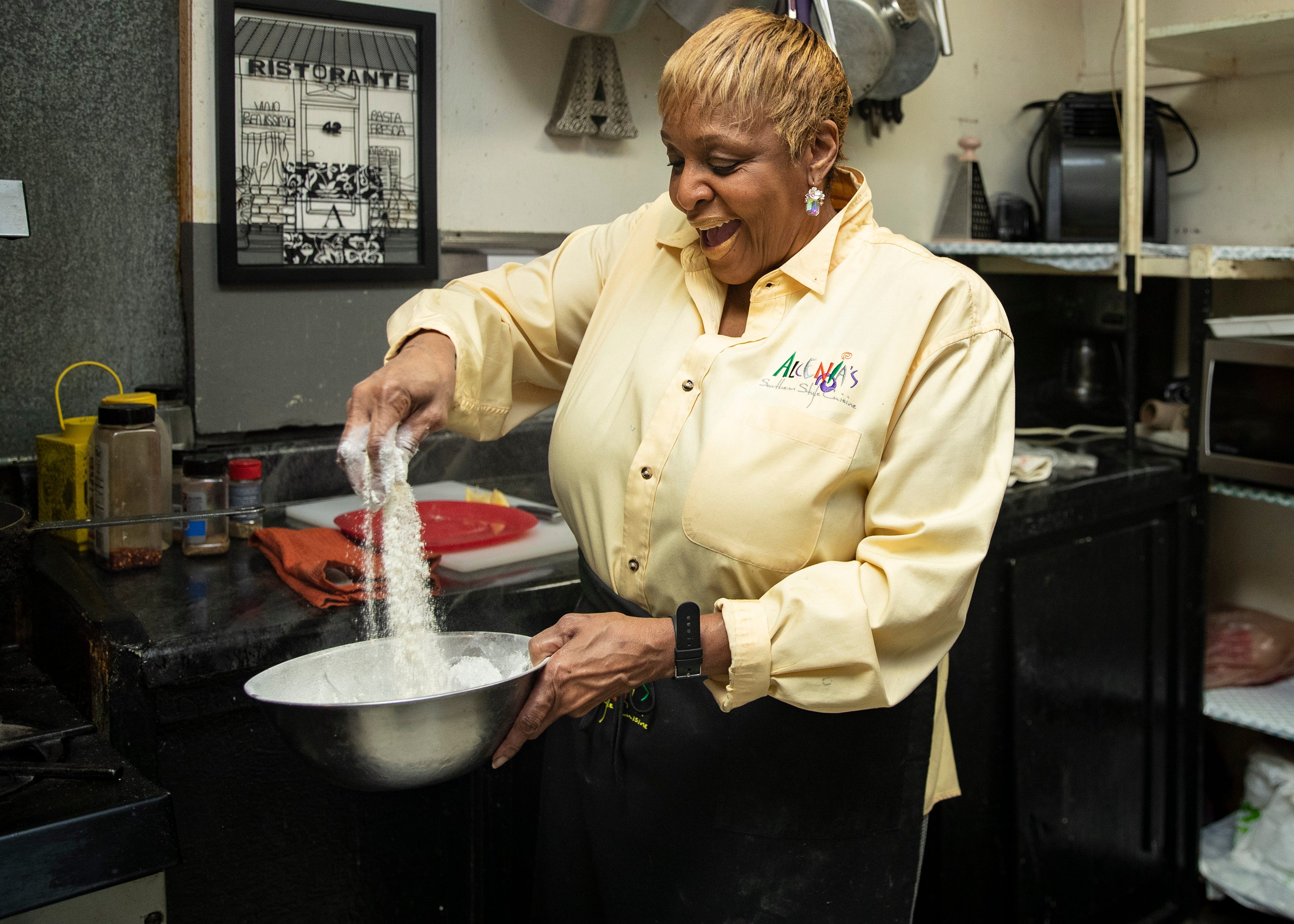 BJ Chester-Tamayo, owner of Alcenia's, a soul food restaurant prepares fried tilapia  in downtown Memphis on Friday, March 5, 2021.