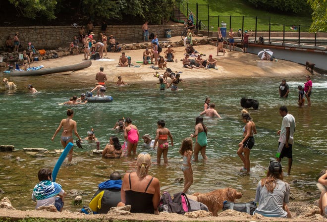 Last summer, people took to Barton Creek near Barton Springs Pool to cool off just before July Fourth as a surge of coronavirus cases was hitting Central Texas. This year, Central Texas is no longer experiencing a surge, but doctors are seeing younger people with severe cases because they are not vaccinated.