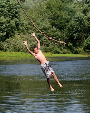 A camper rushes into Lake Mvima on a rope swing at Camp Fitch in Springfield Township, Pennsylvania.