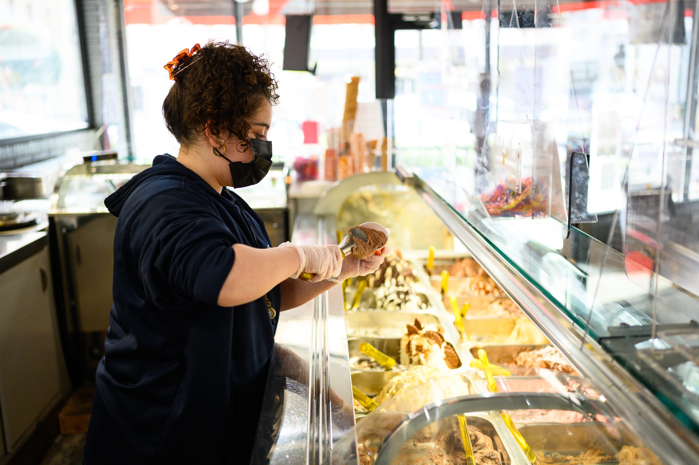 Mia Ortiz scoops a cup of gelato for her brother Luca at Luna Rosa Gelato Cafe downtown Thursday, March 11, 2021.