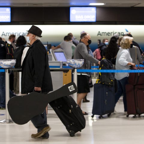 Travelers wait in line at ticketing at Terminal 4 