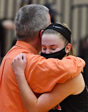 Central York Head Coach Scott Wisner embraces Sarah Berman as she leaves the court in the final quarter during District 3, Class 6-A girls basketball championship action at Cumberland Valley High School in Mechanicsburg, Thursday, March 11, 2021. Central York would fall to Cumberland Valley 64-41. Dawn J. Sagert photo