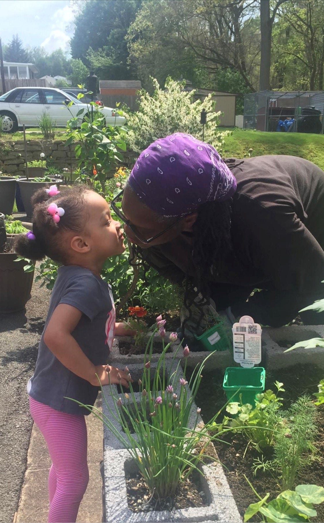 "Gardening allows me to commune with my ancestors. It allows me to commune with Mother Earth. It allows me to commune with God," said Janet Carter, 61, seen here with her granddaughter.