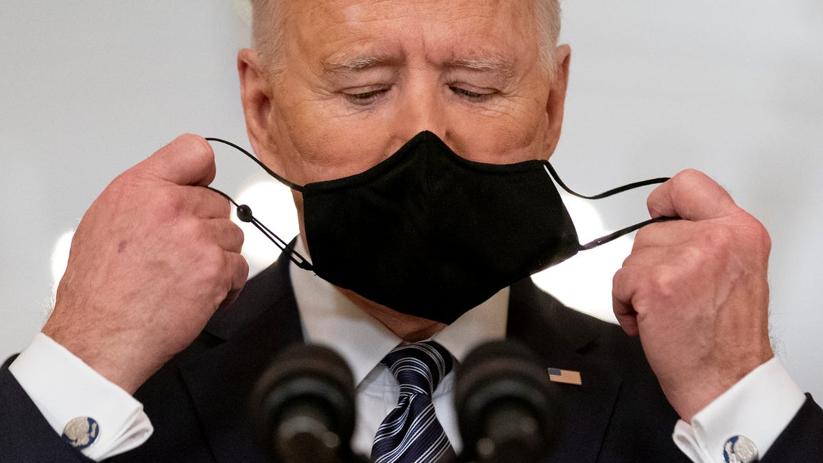 President Joe Biden takes off his mask to speak about the COVID-19 pandemic during a prime-time address from the East Room of the White House, Thursday, March 11, 2021, in Washington.