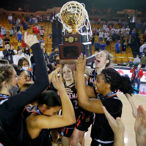 Norman celebrates with the trophy after beating Bi