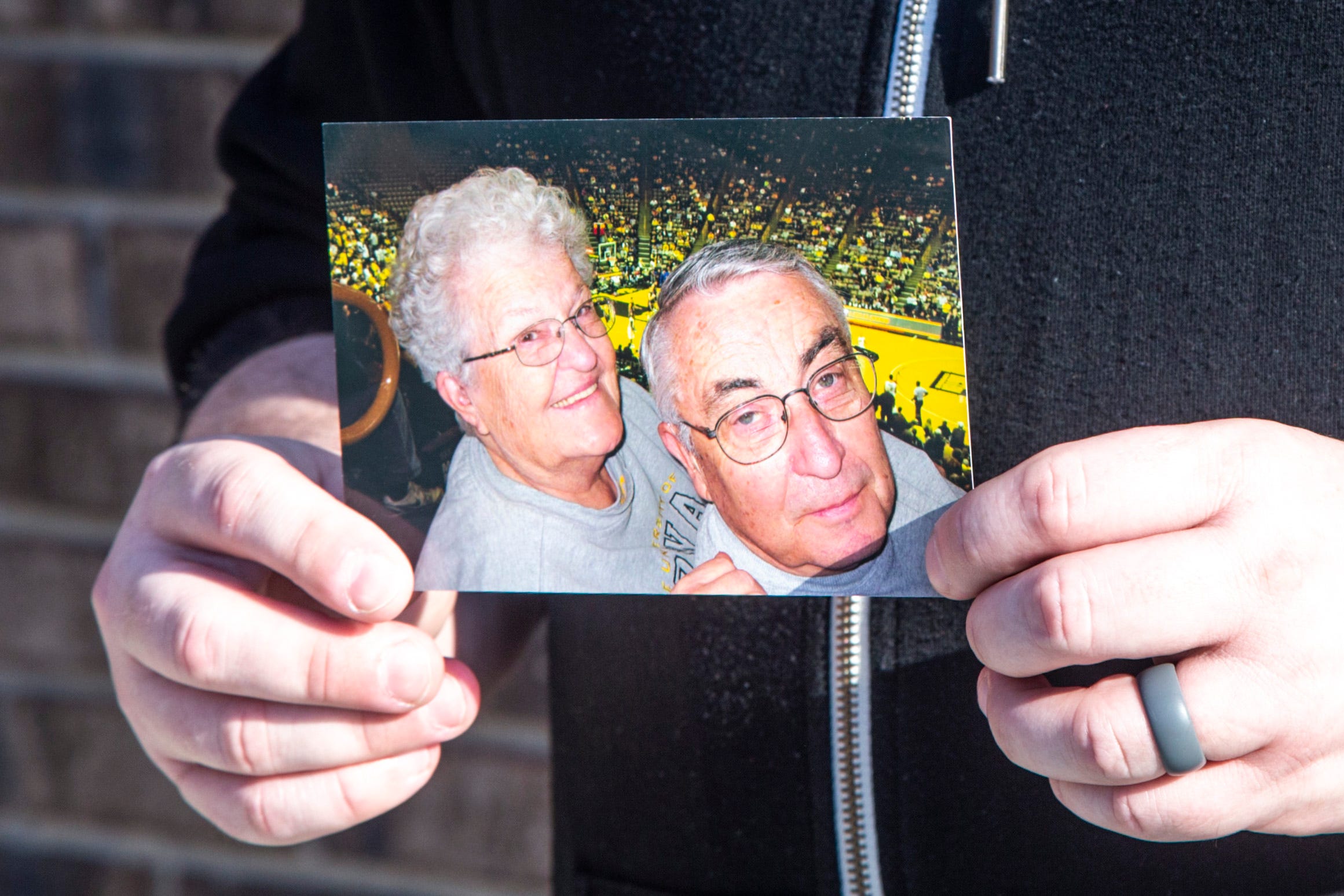 Adam Skibbe holds a photo of his grandparents Jane and Norry Gronert, Sunday, March 7, 2021, in Tiffin, Iowa. The two were attending a men's basketball game at Carver-Hawkeye Arena.