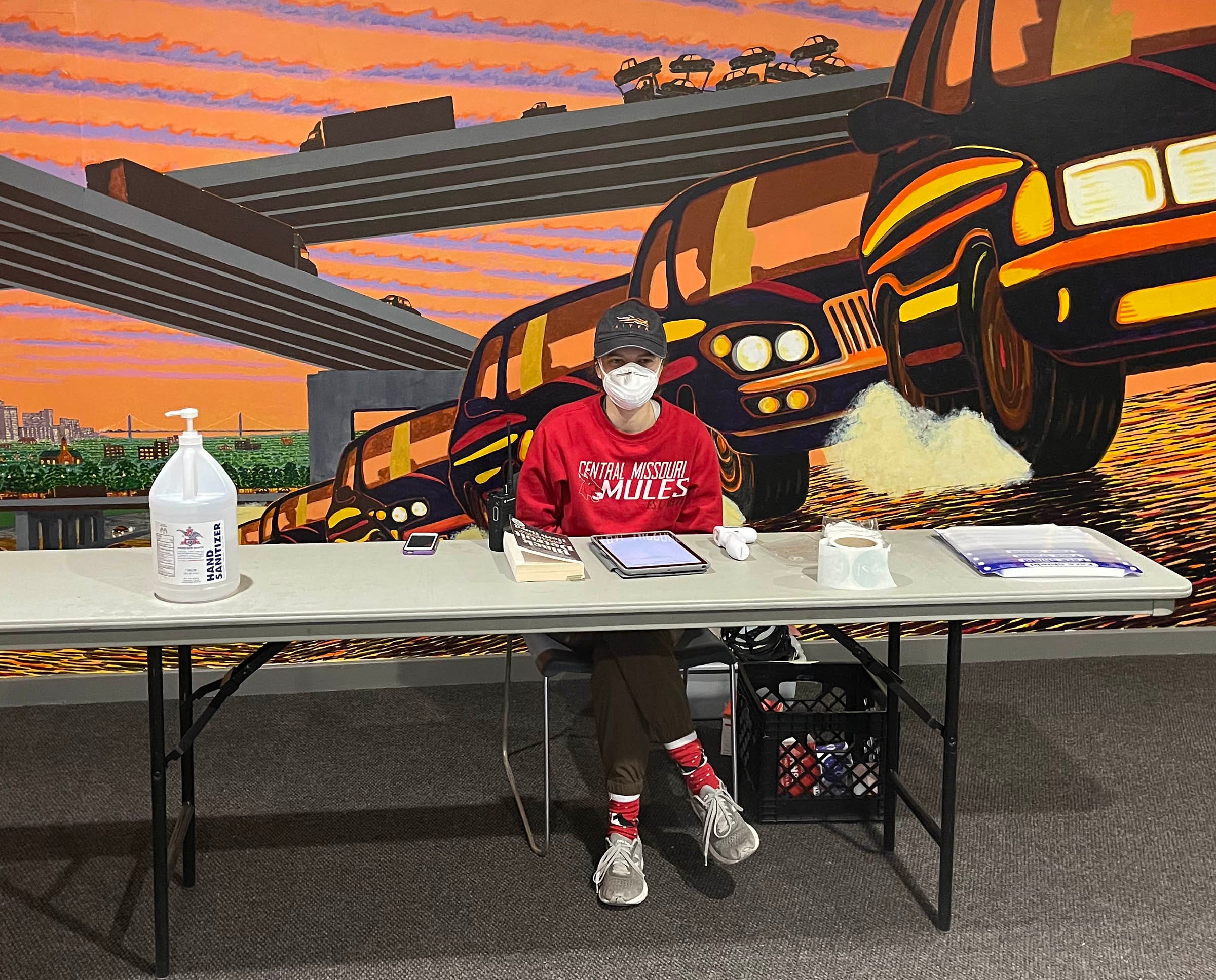 Sarah Paulsrud, 23, moved to Detroit from Lee's Summit, Missouri in August to help with Pope Francis Center. She is seen here on Saturday, March 6, 2021, checking volunteers into the TCF Center prior to doors opening at 7 a.m. This is the entrance near the rooftop parking.