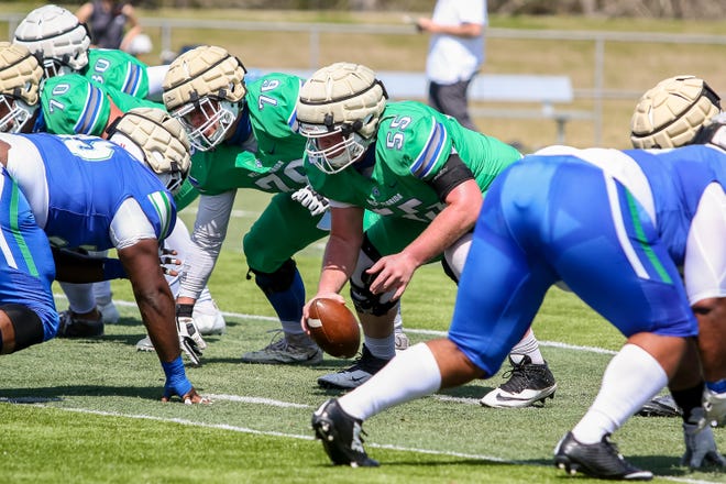 Center Dalton Simpler (55) snaps the ball during UWF's Blue vs. Green spring game at Pen Air Field on campus on Saturday, March 13, 2021.